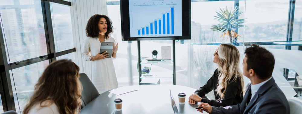 people in a board room looking at a presentation